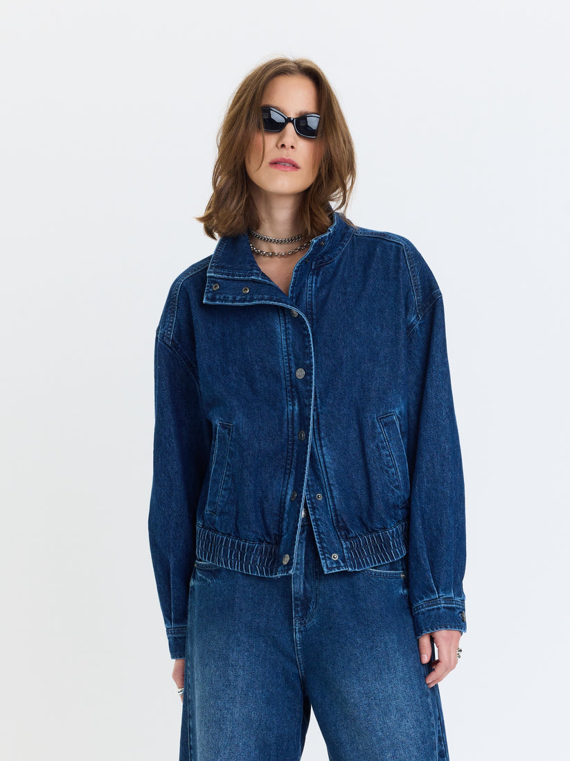 Blue denim funnel-neck jacket with snap front, elastic waist, chest buttons
