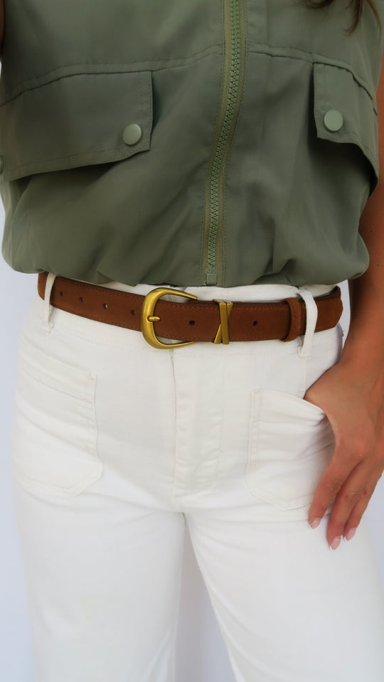 Brown suede belt with gold-tone buckle and keeper, worn with jeans