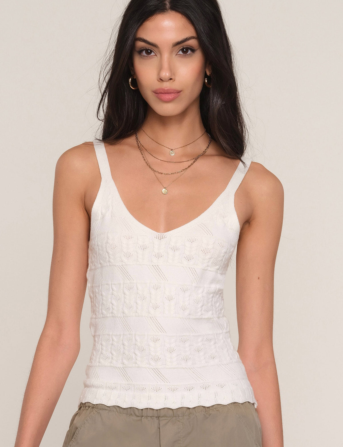 White cami top with V-neck and thin straps, textured lace panel and straight hem