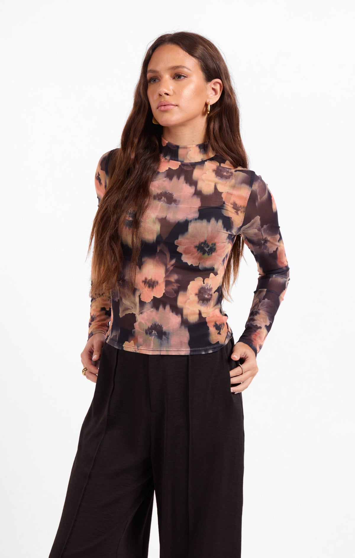 Front view floral knit top with long sleeves and high neck, dark peach and black print