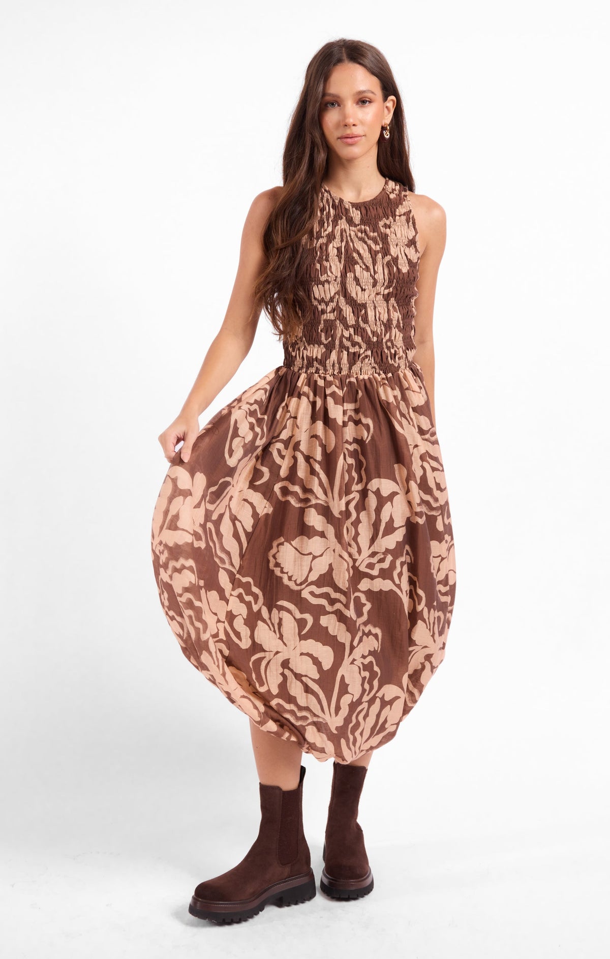 Brown patterned midi dress with sleeveless high neck and smocked waist, gathered skirt