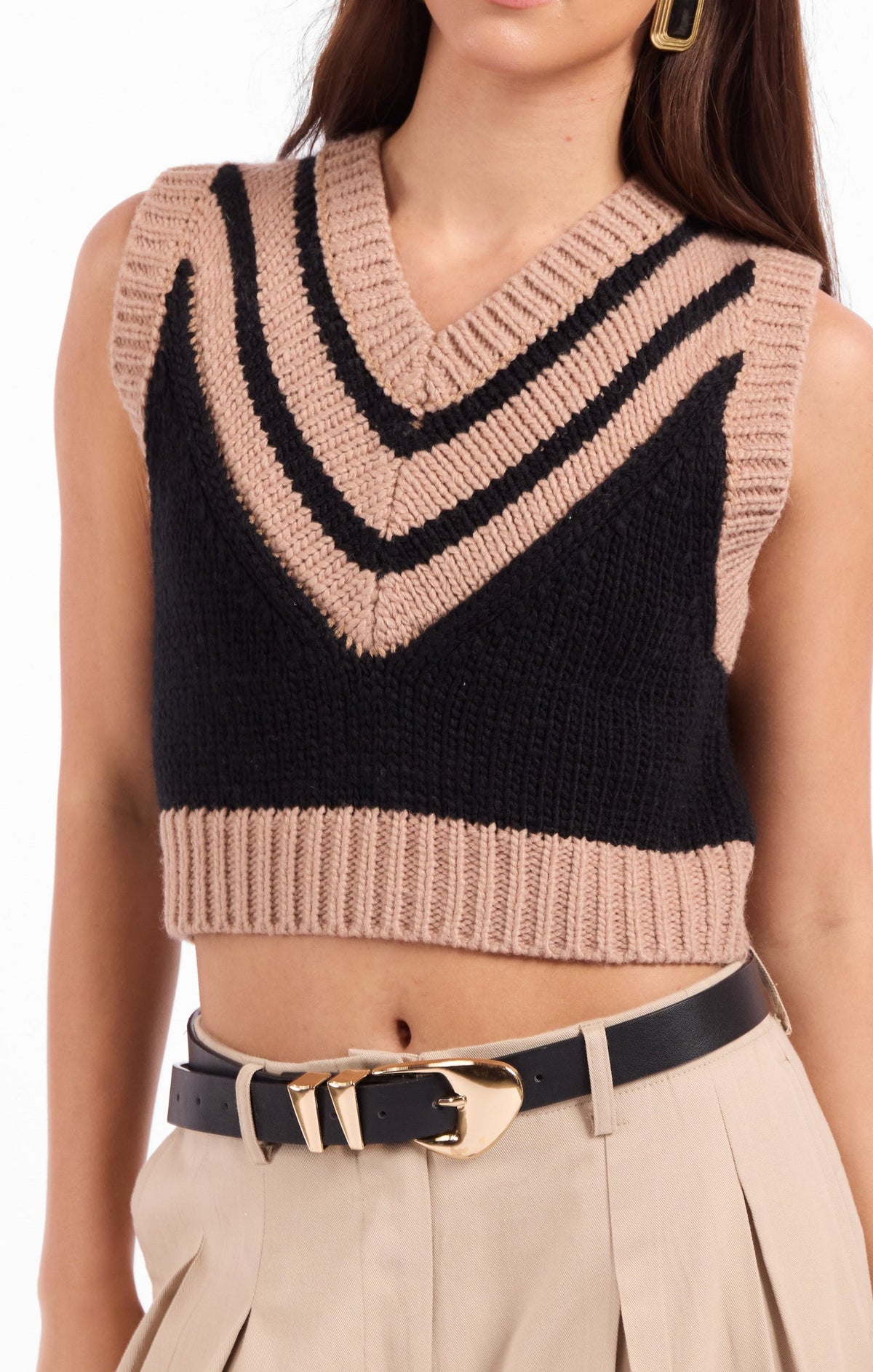 Close-up black knit sweater vest with beige and black striped V neckline