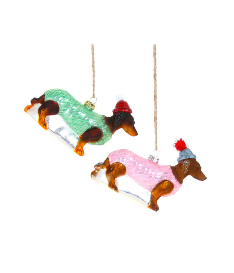 Hanging dachshund ornament with green knit sweater and red hat detail