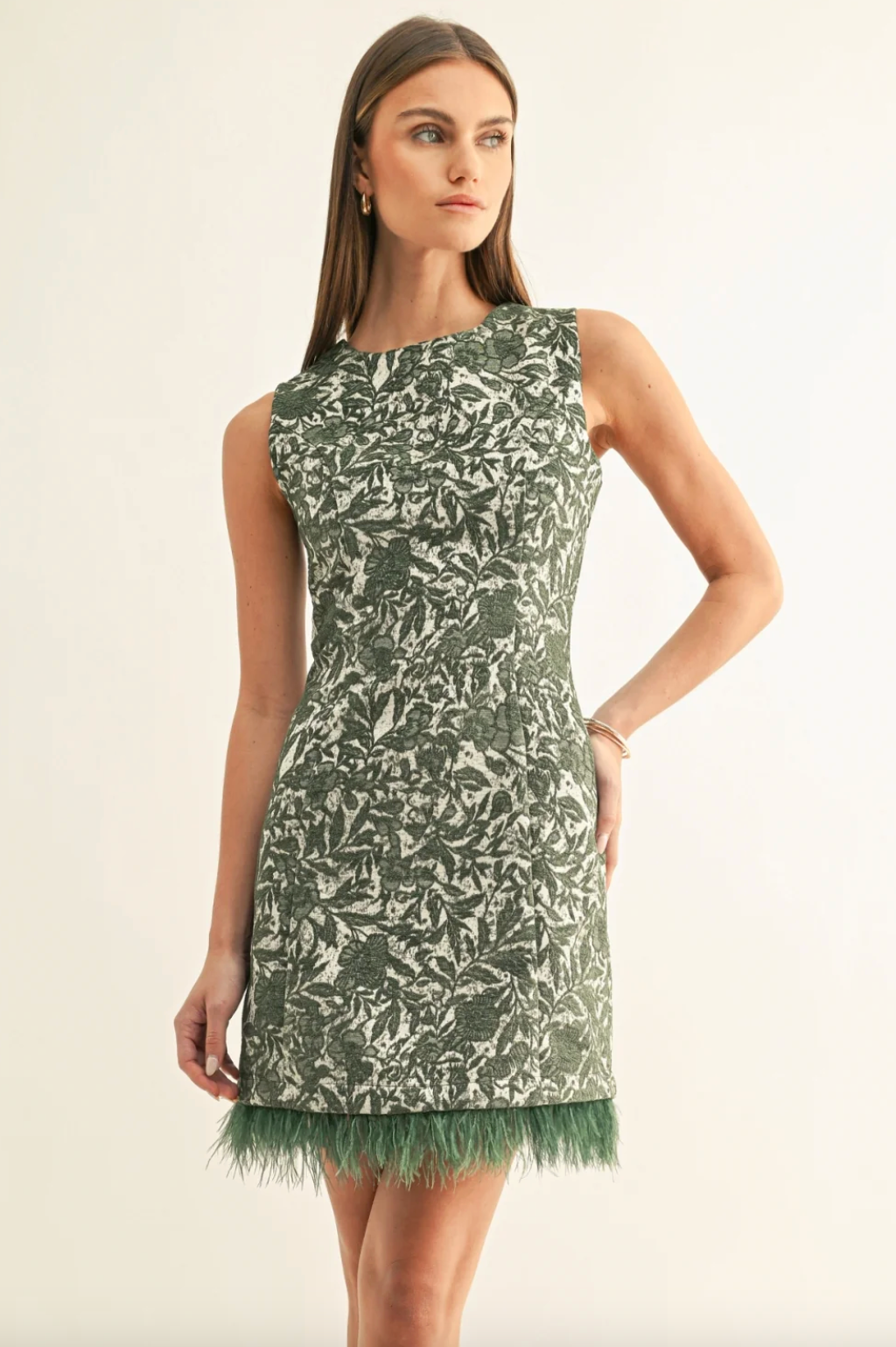 Sleeveless shift dress with high neckline, green-and-white leaf print, faux feather trim