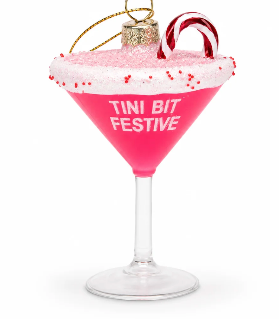 Pink martini glass holiday ornament reading 'Tini Bit Festive' with red ribbon