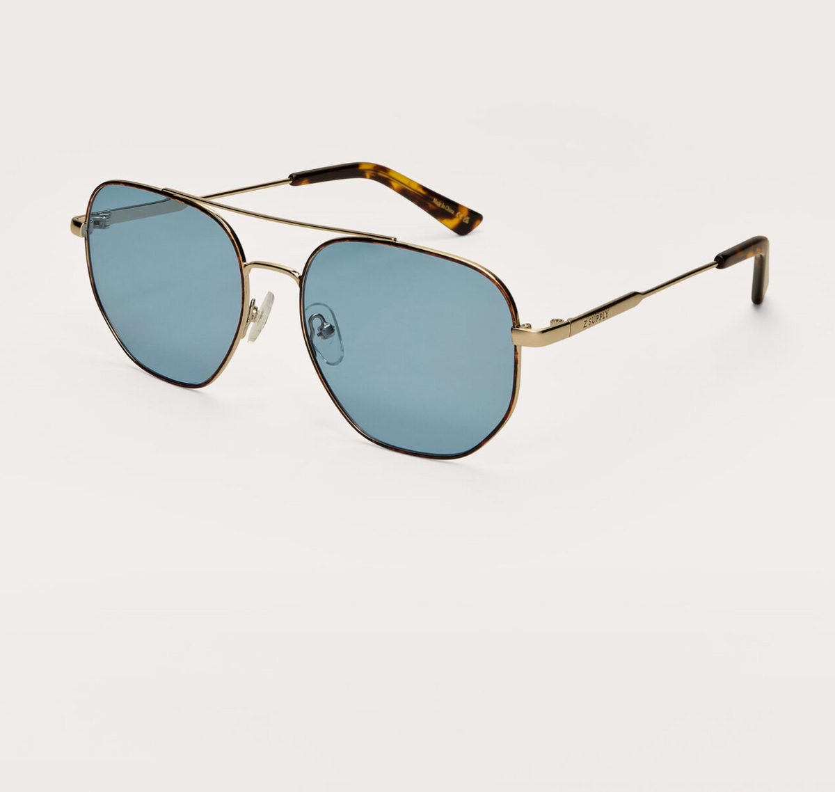 Gold-tone polarized sunglasses with blue lenses and tortoise-pattern arms, angled view