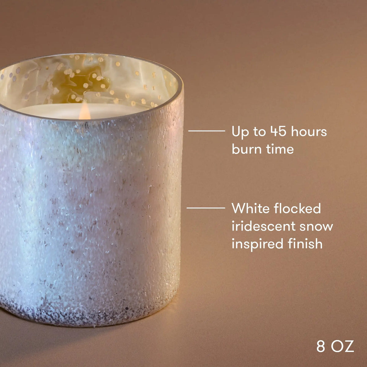 8 oz frosted tumbler candle in pale blue-gray with flame, white flaked wax texture