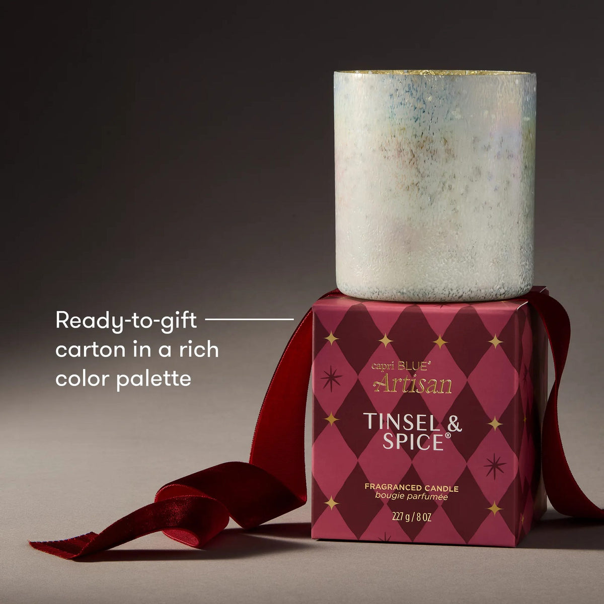 Holiday boxed tumbler with red ribbon, gold speckled lid, and Tinsel & Spice label