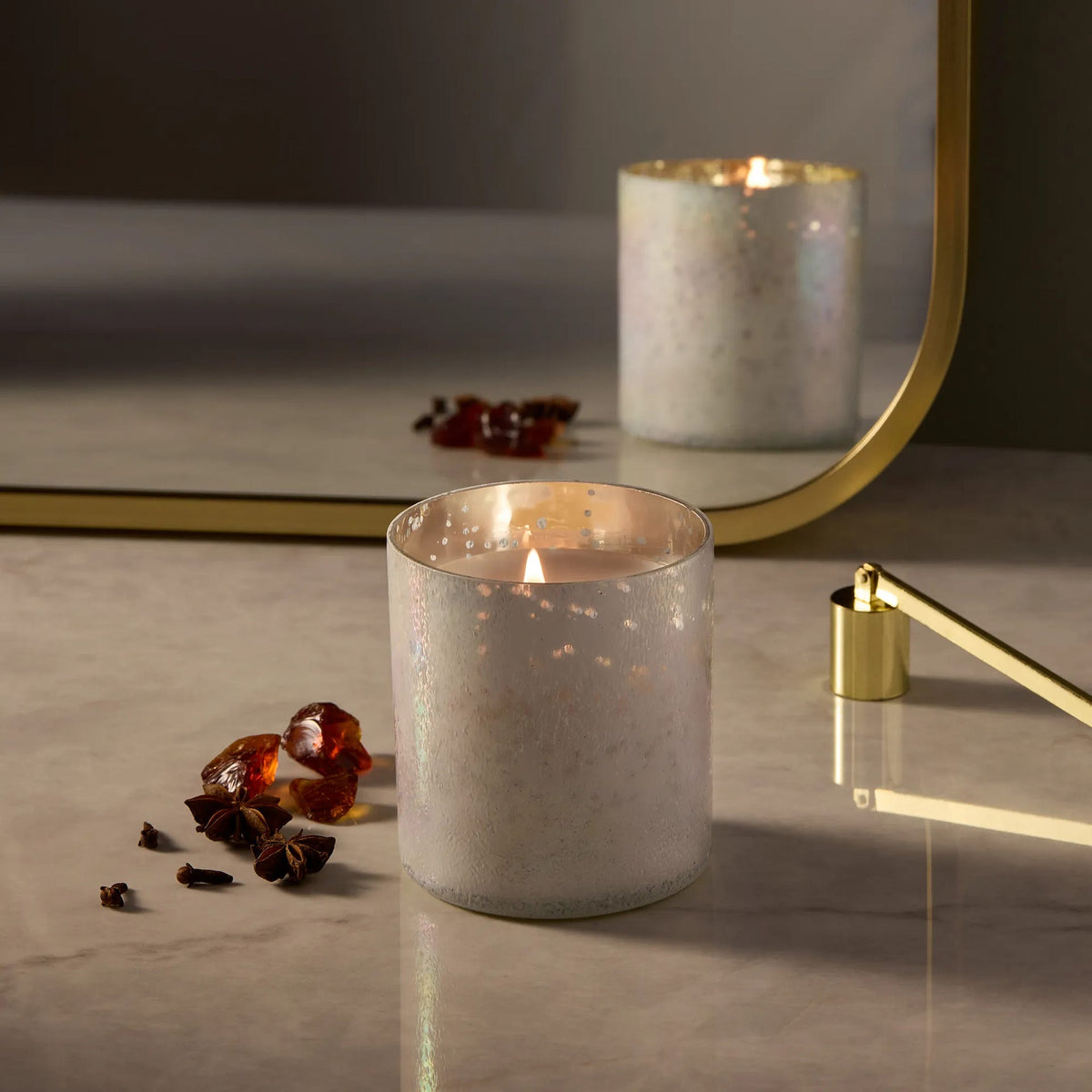Frosted wax tumbler candle with steady flame, silver-gray speckled finish