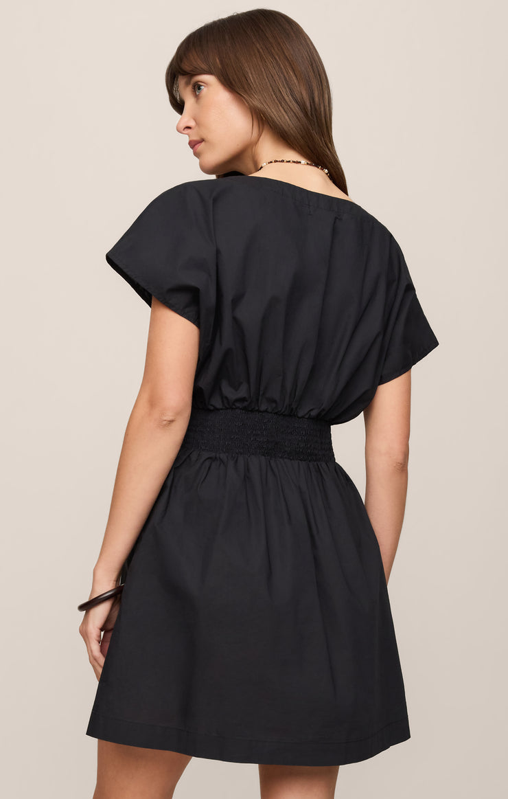 Black poplin mini dress back view with V-neck, buttoned yoke, gathered waist