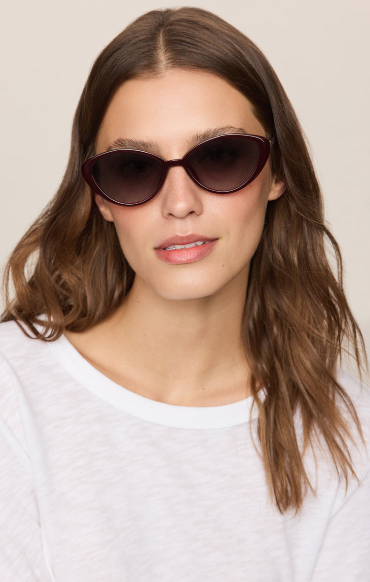 Nouveau polarized sunglasses on model with dark lenses and dark burgundy frames
