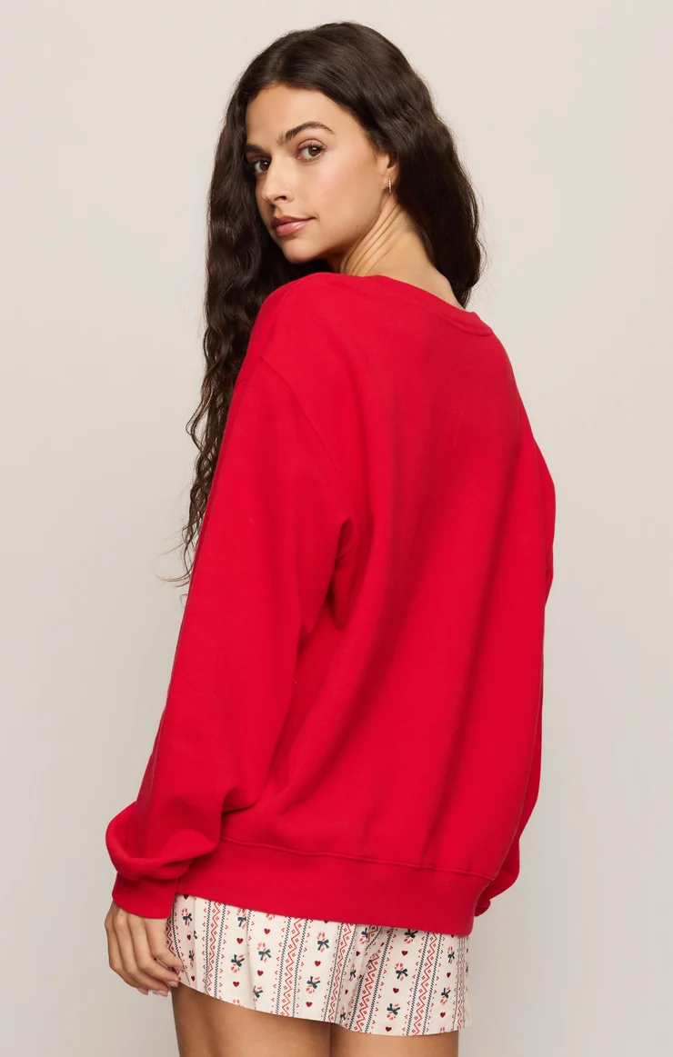 Ruby red sweatshirt with ribbed cuffs, side/back view, no front print visible