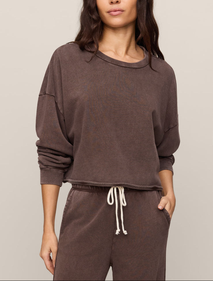 Dark brown crew neck sweatshirt with relaxed fit and rolled cuffs