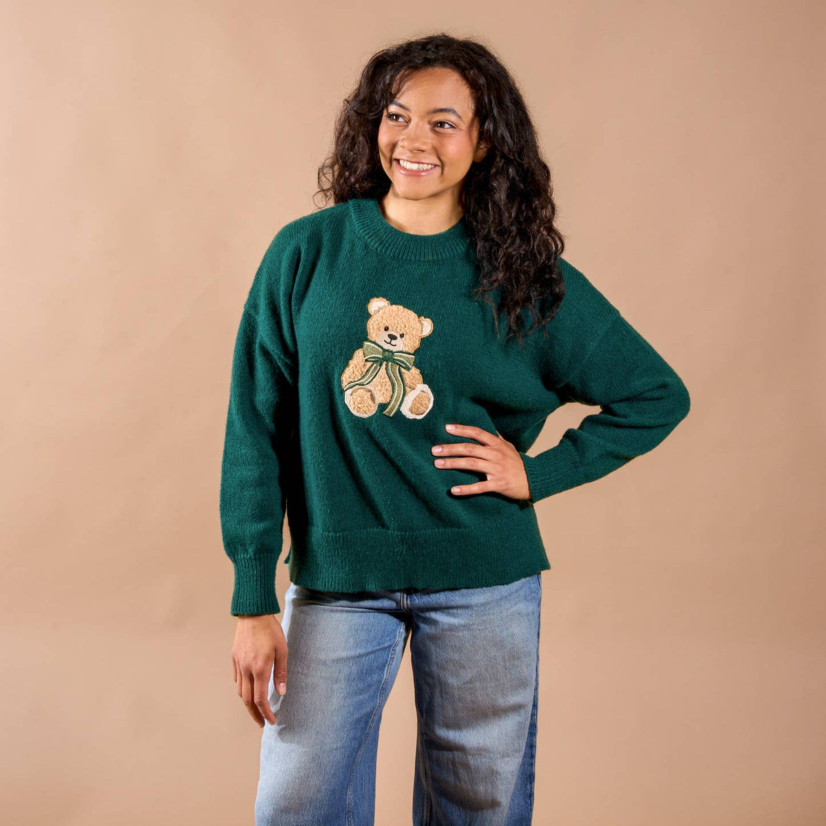 Women’s teal crewneck sweater with teddy bear graphic; long sleeves and ribbed trim