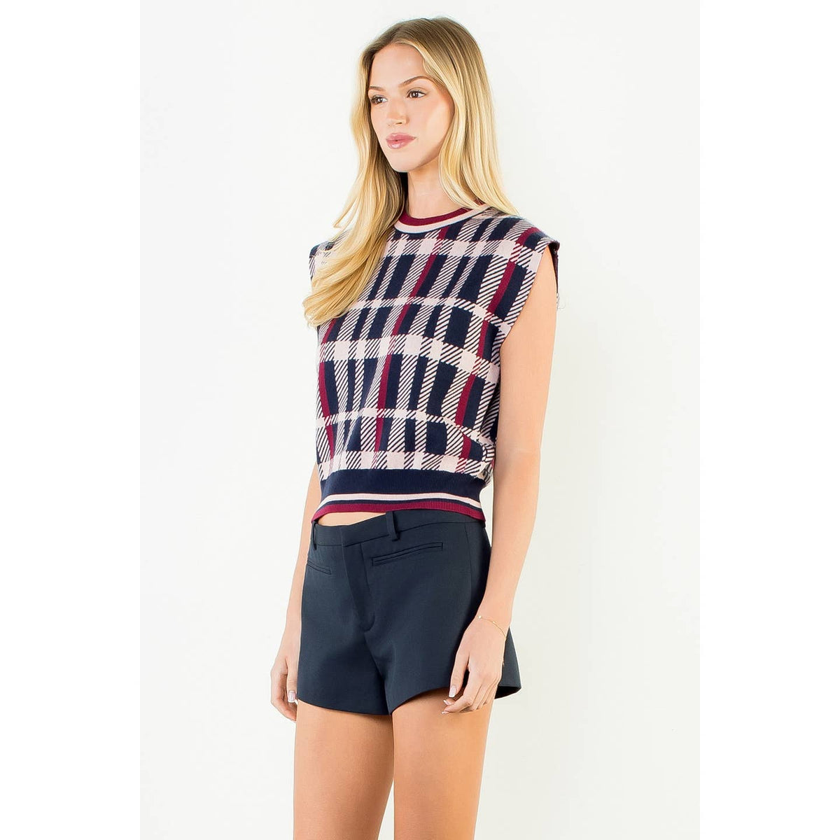 Plaid sleeveless sweater vest with ribbed trim at crew neck and hem, navy red cream