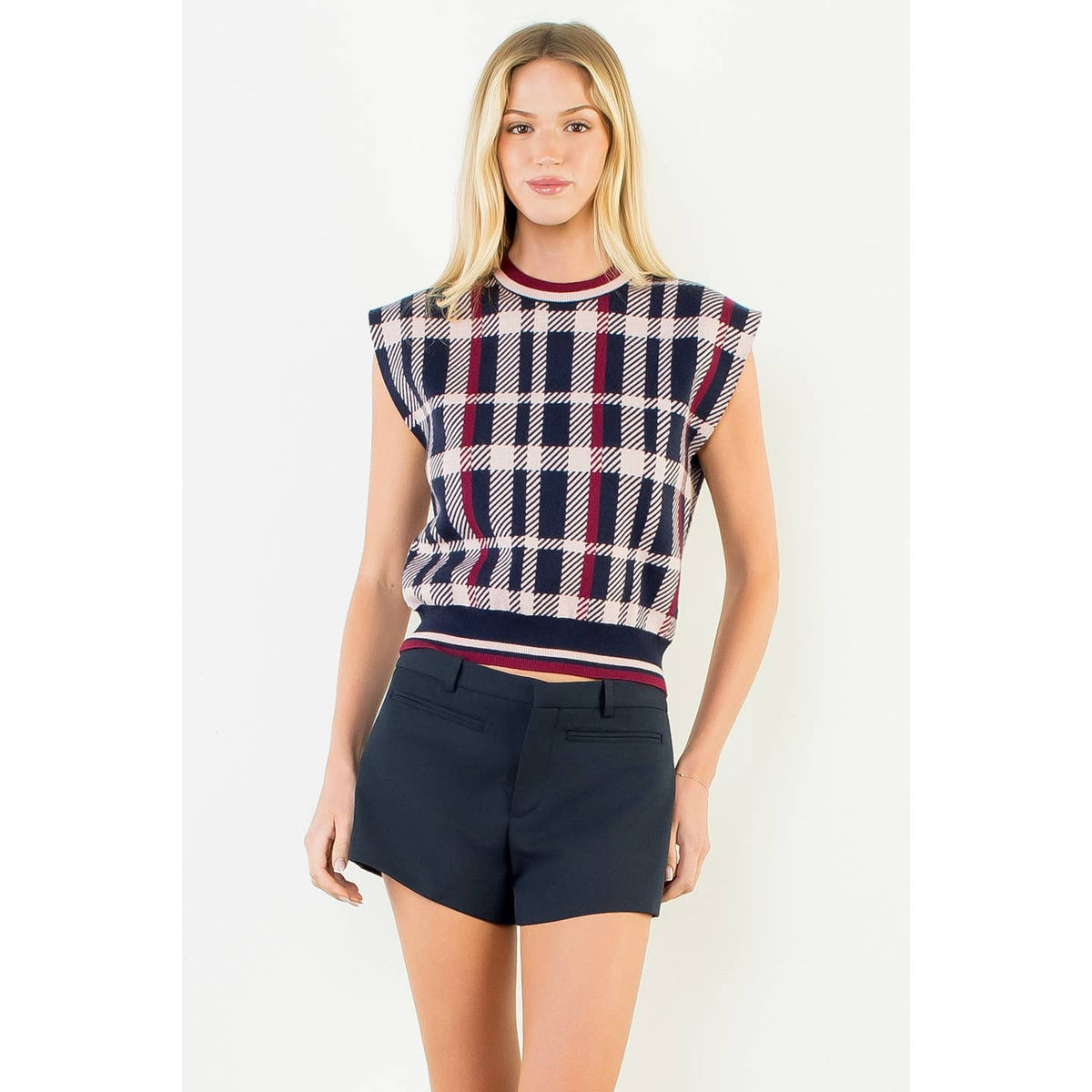 Sleeveless plaid sweater vest in navy, red, and cream with ribbed crew neck