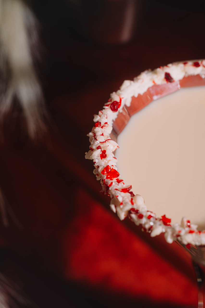 Martini glass rim covered with red-and-white candy cane crumbles