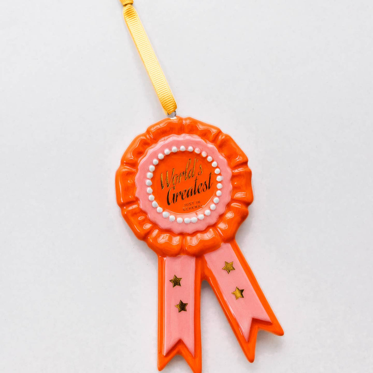 Orange rosette ornament with pink center text and star ribbons, yellow hanging cord
