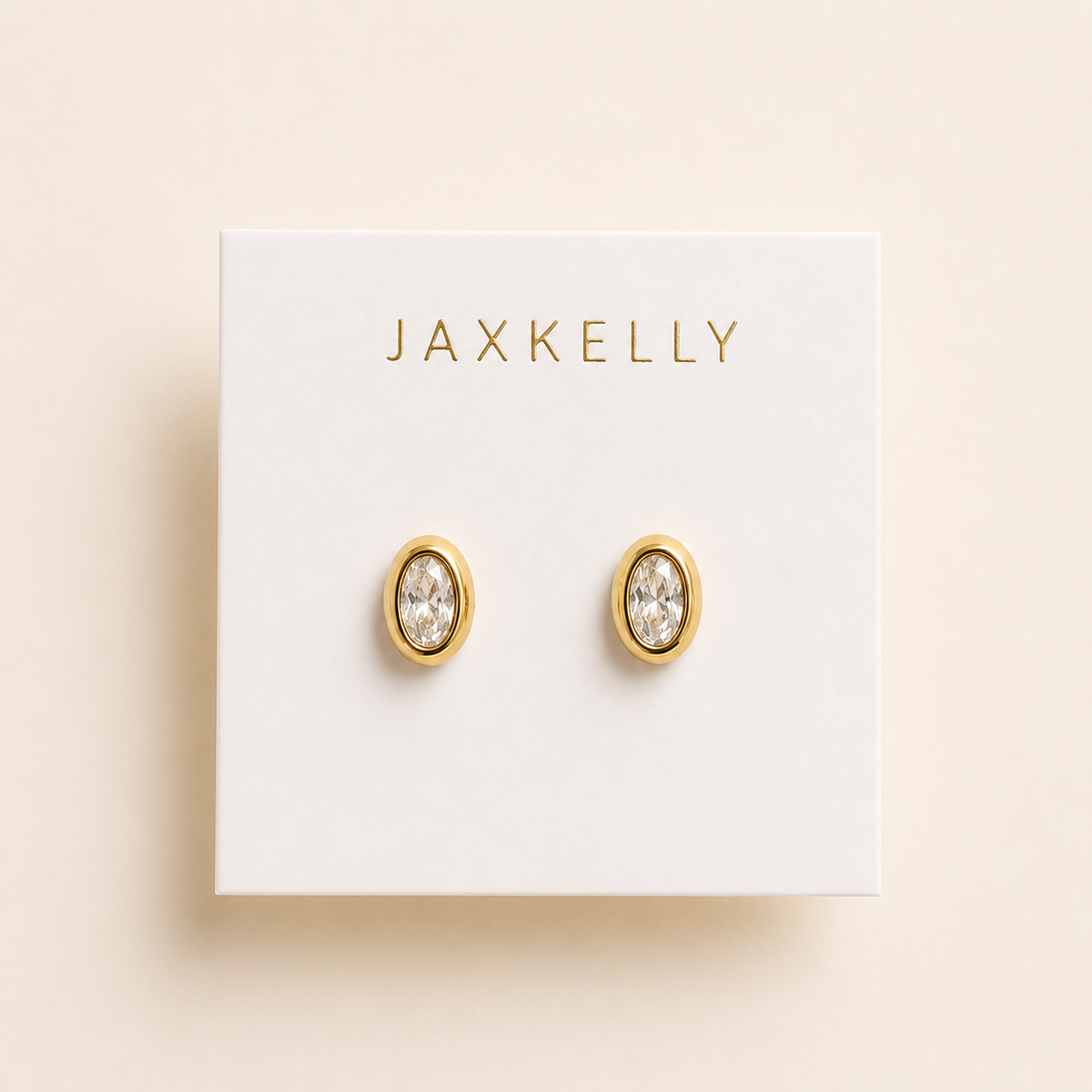 Oval bezel CZ stud earrings with clear stones in gold-tone settings