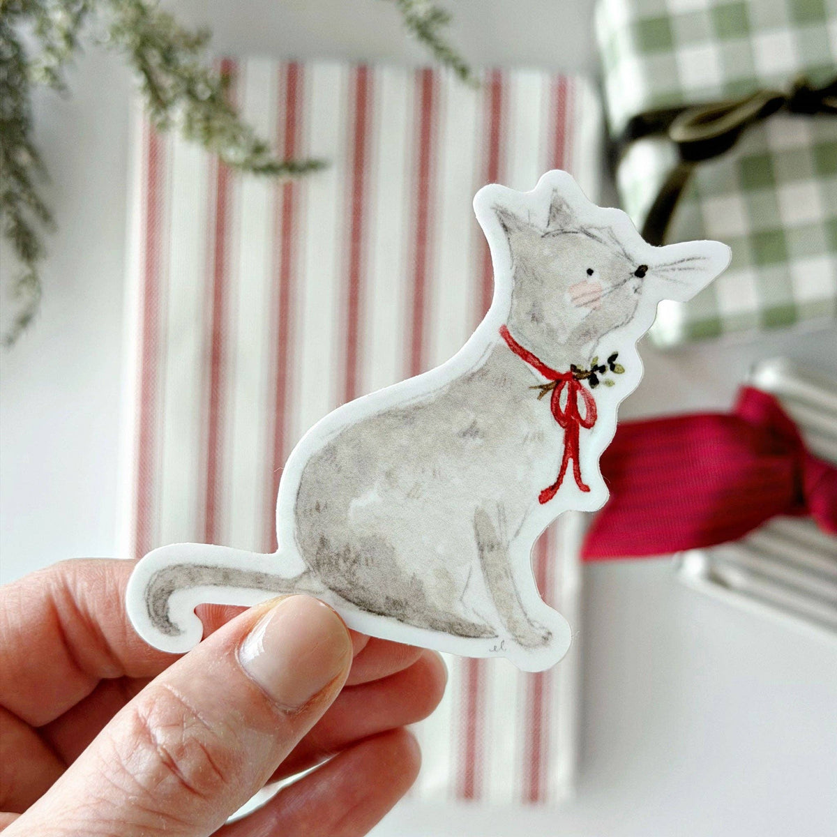 Grey cat Christmas sticker with red bow, white outline