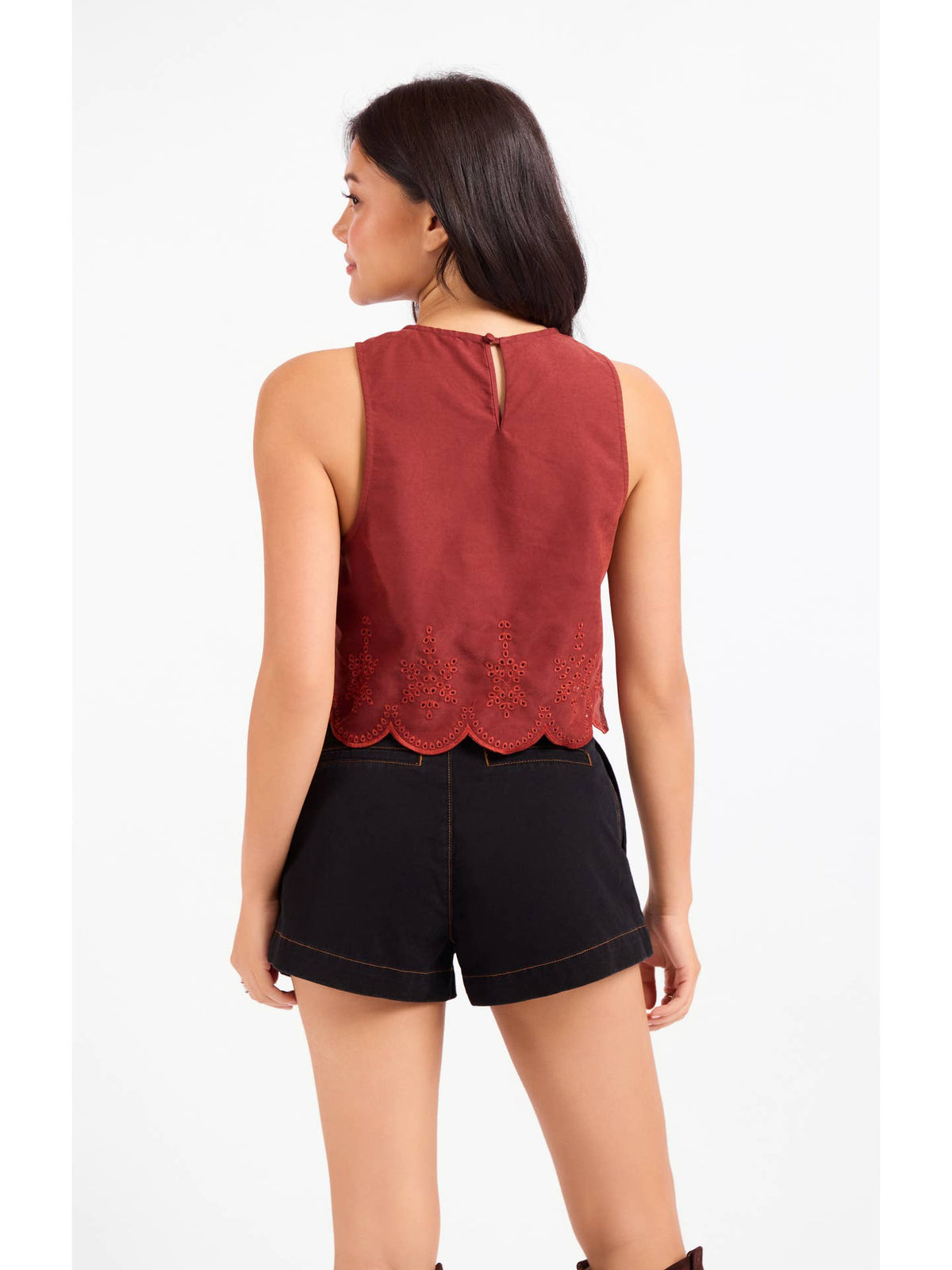 Sleeveless rust top from the back with keyhole neck and scallop-hem eyelet detail
