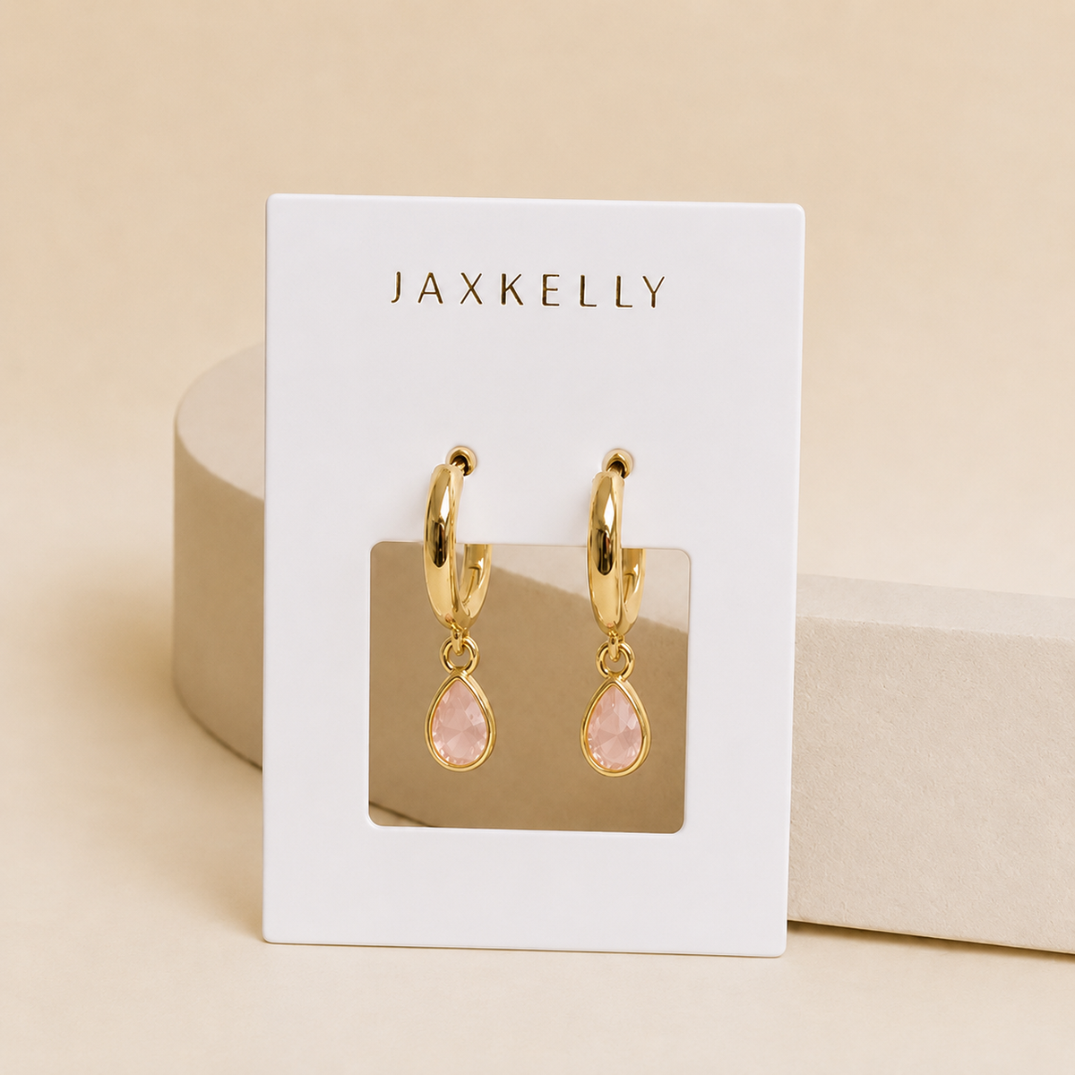 Gold teardrop charm hoop earrings with rose quartz-pink stones