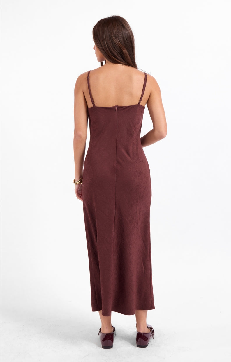 Burgundy open-back slip dress with spaghetti straps, fitted midi length.
