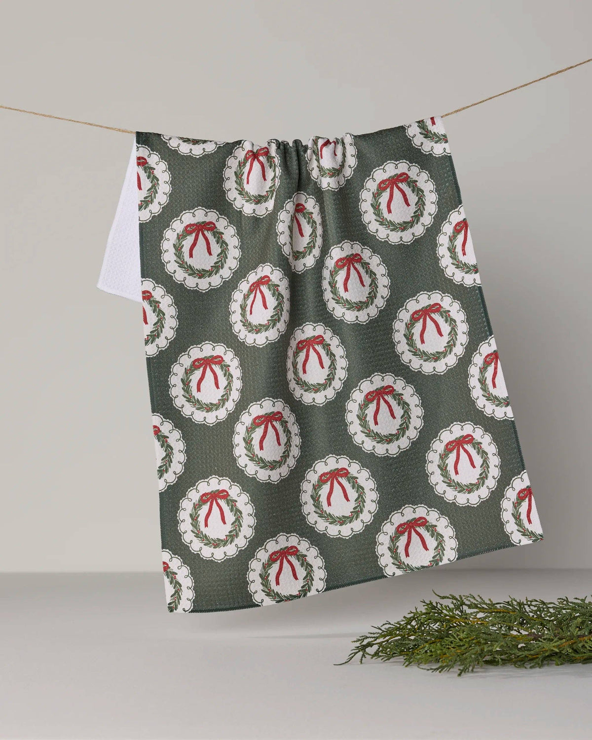 Holiday tea towel with wreath ornament prints, gray-green with red bows
