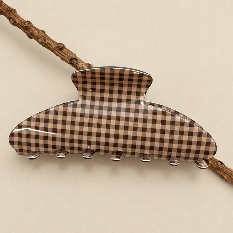 Brown plaid oval jumbo hair claw clip with ridged clasp teeth.