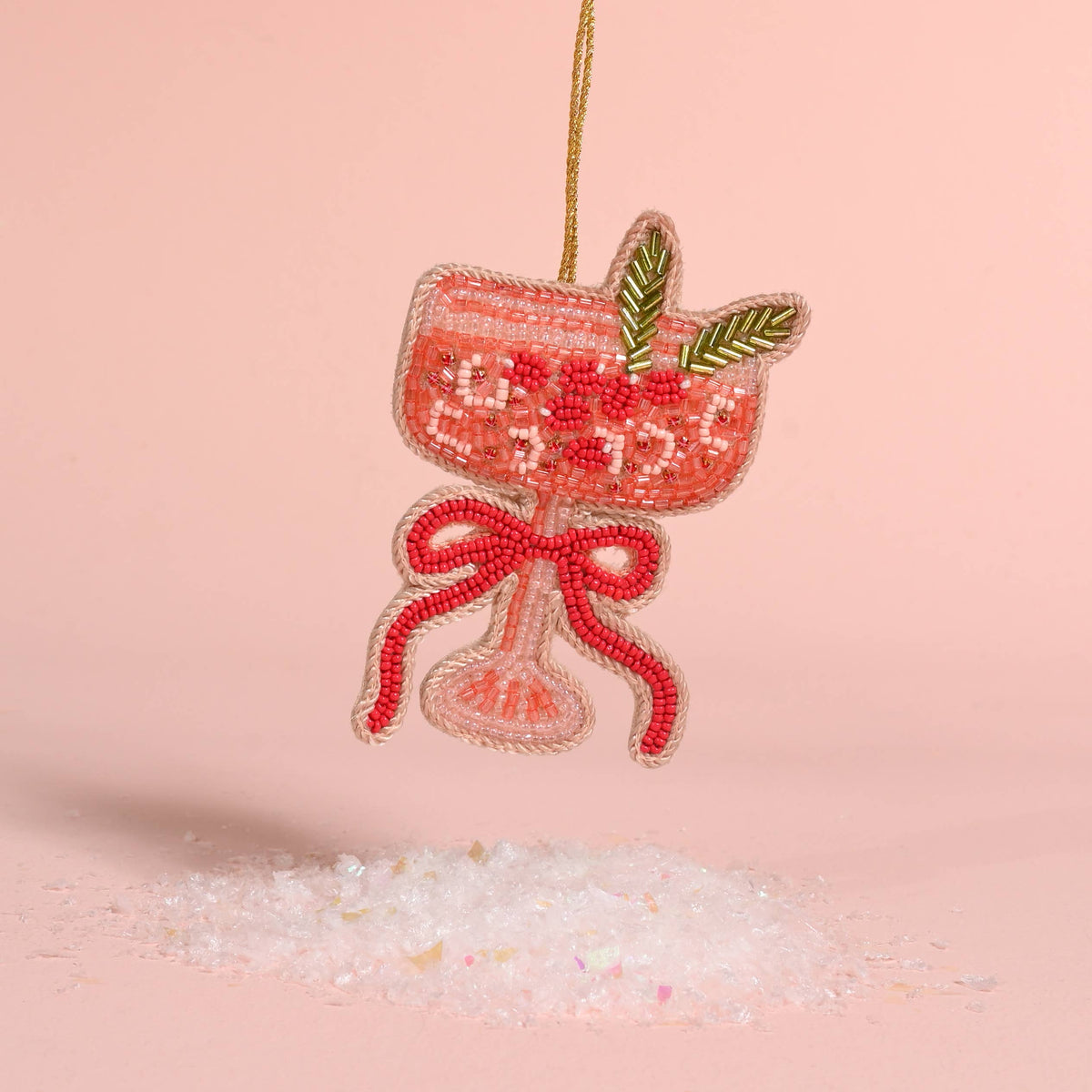 Beaded cranberry-red ornament with bow, green leaf accents, and hanging cord loop