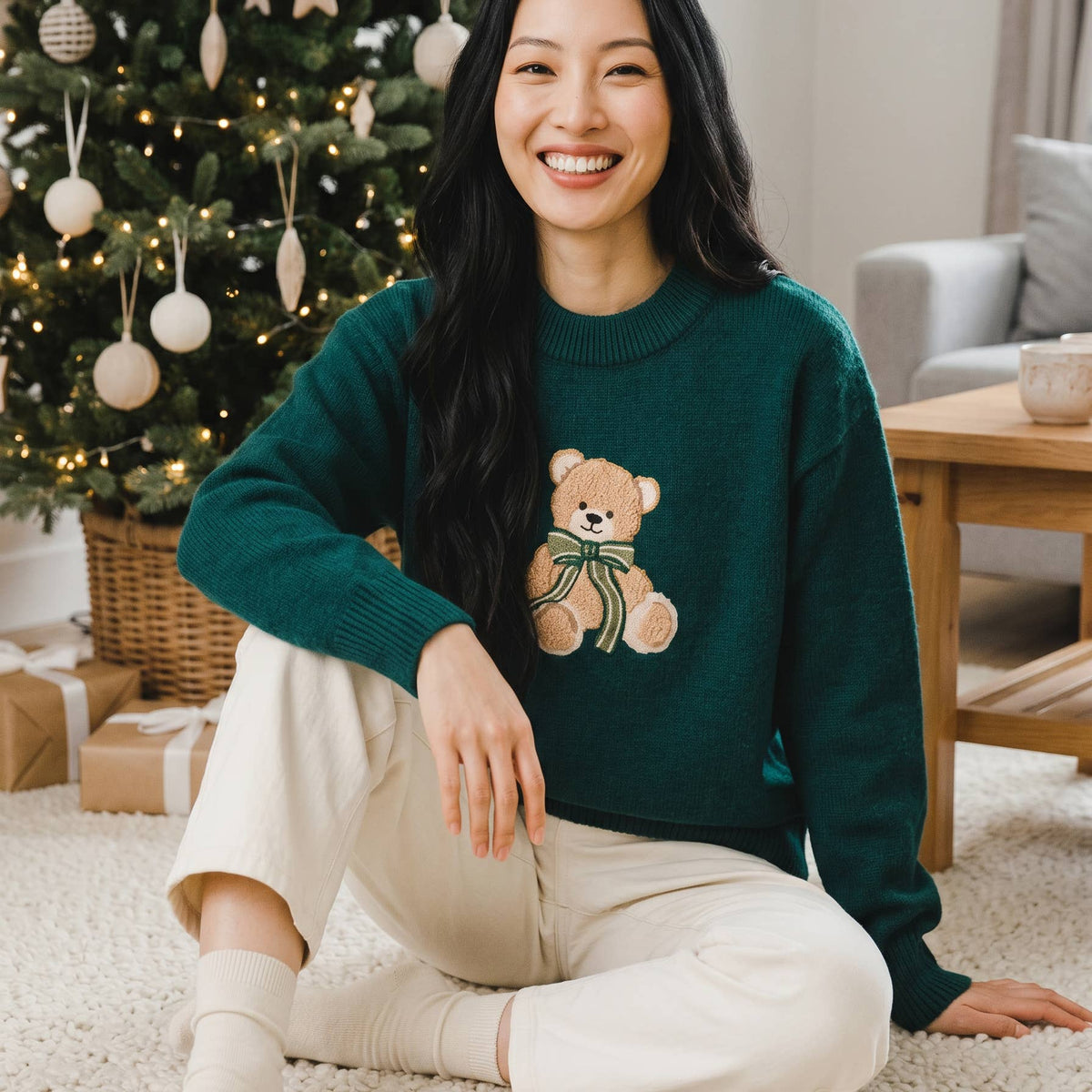 Teal crewneck sweater featuring a teddy bear graphic; ribbed collar and long sleeves