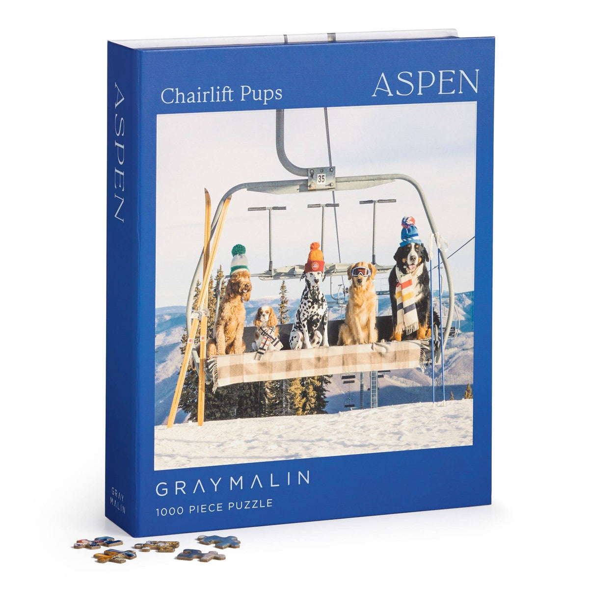 Blue 1000-piece jigsaw puzzle box with dogs on a ski chairlift, plus pieces