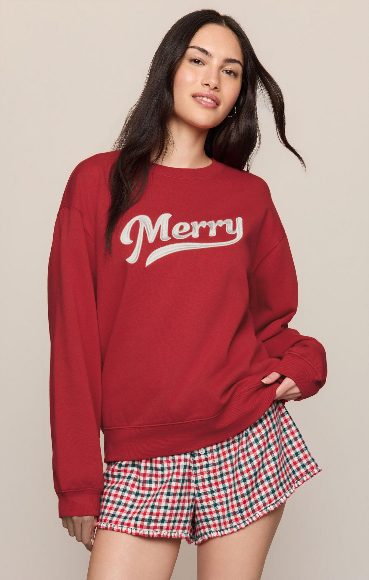 Ruby red sweatshirt with 'Merry' front graphic, crew neck and long sleeves.