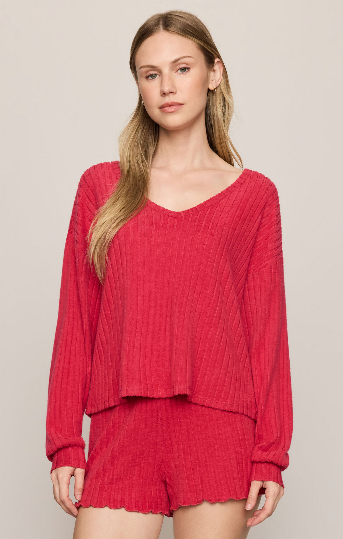 Ruby red V-neck ribbed knit long-sleeve top with scalloped hem