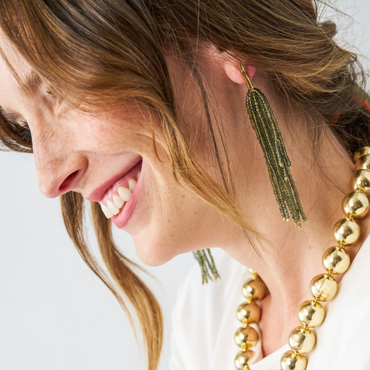 Olive beaded fringe earrings with gold-toned hook and tassel drop