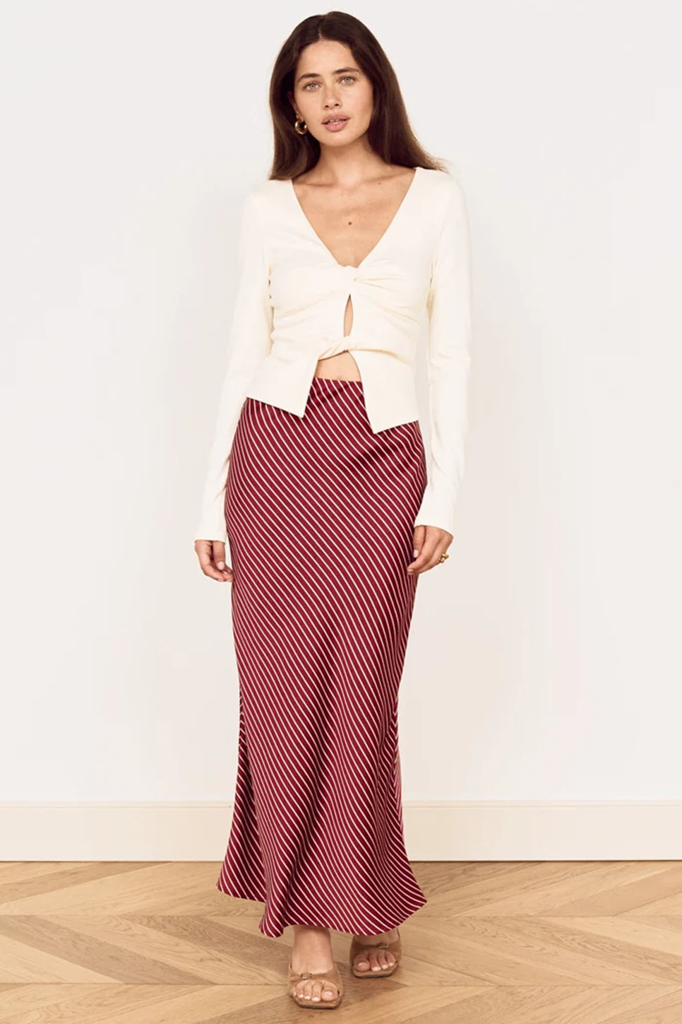 Red and white striped midi bias skirt, flared hem with diagonal stripe pattern.