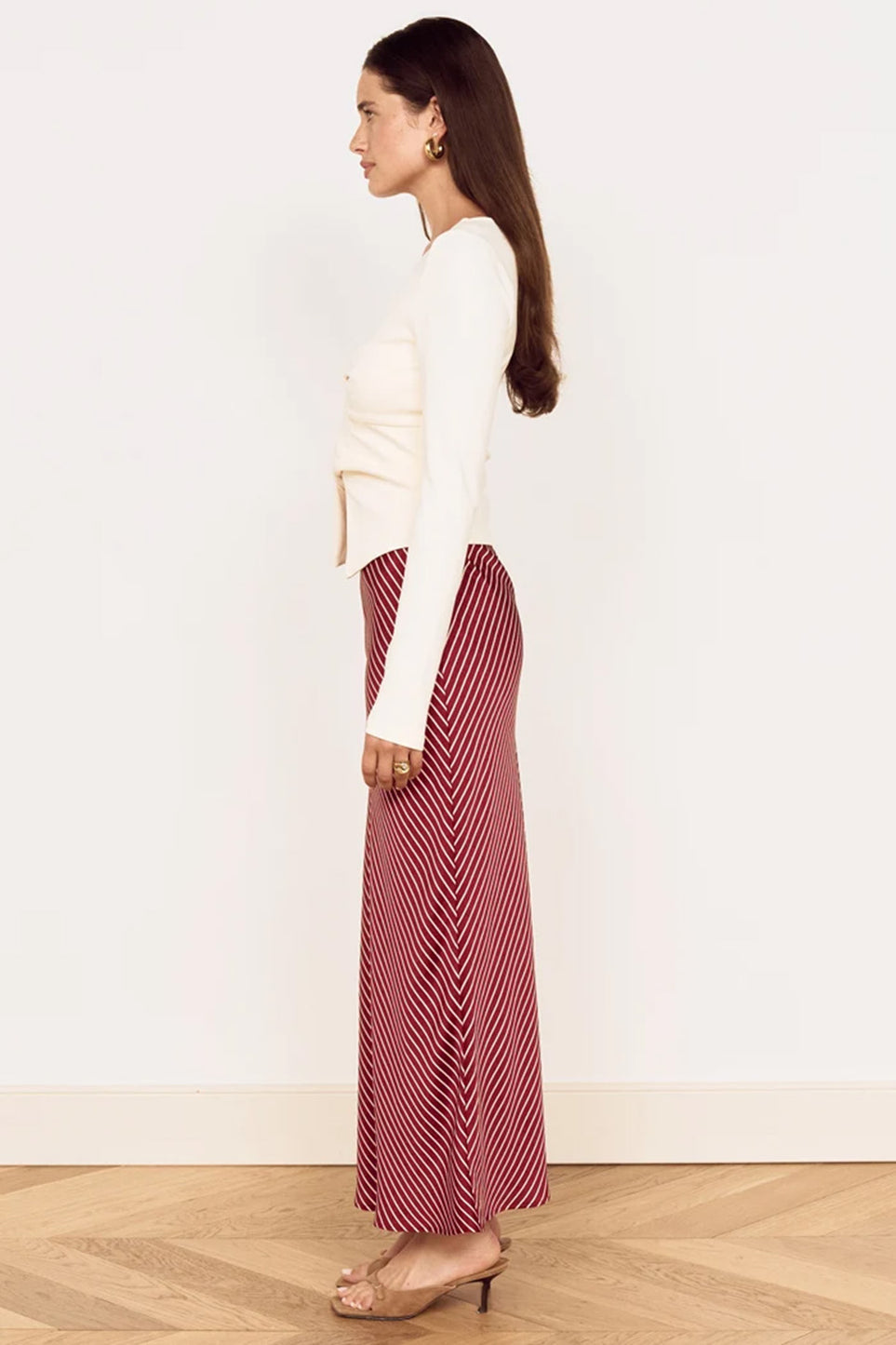 Red and white diagonal-stripe midi skirt with draping flared hem.